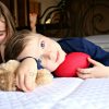 Boy on bed with toy football
