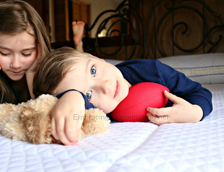 Boy on bed with toy football